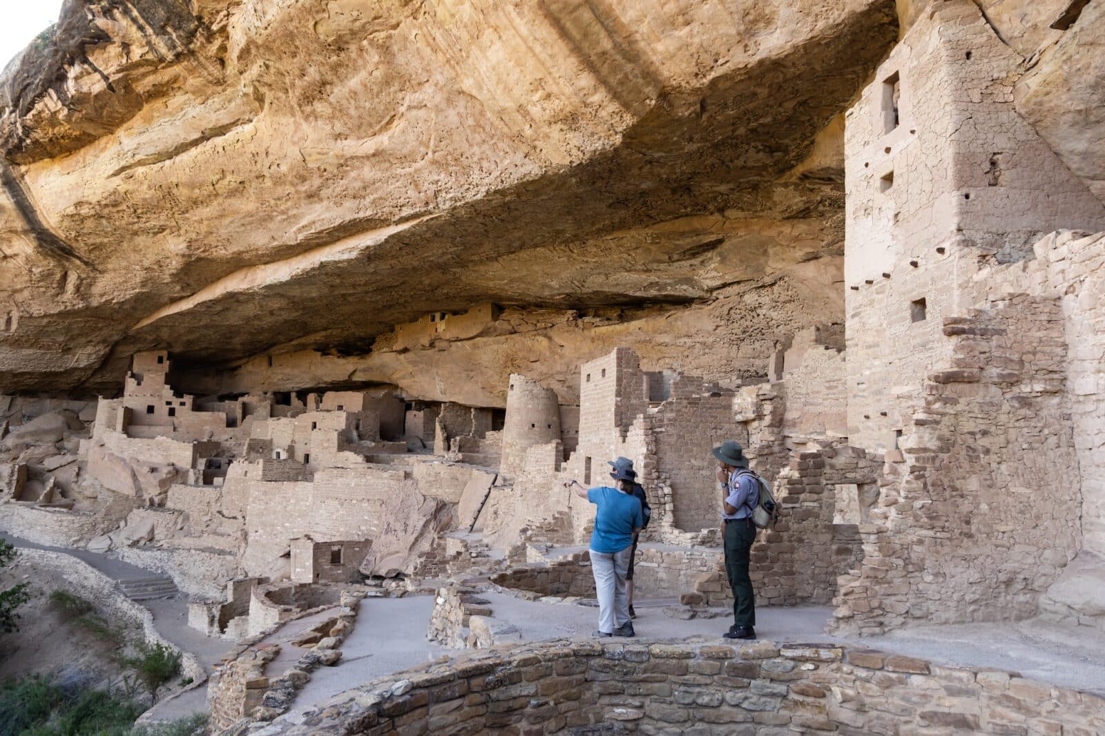 a range talks to a couple of people at Cliff Palace
