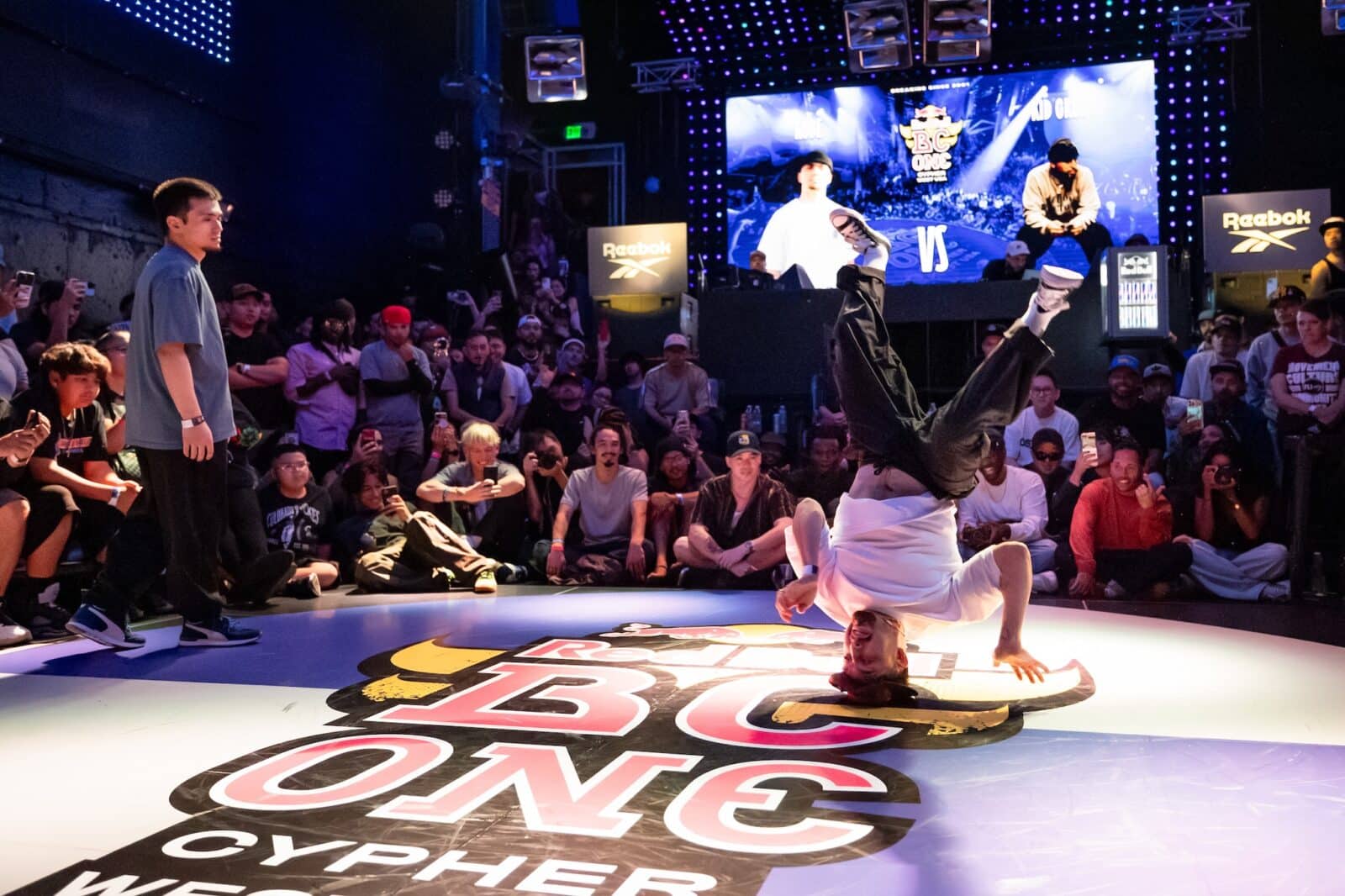The image captures Kid Cruz dancing in the championship round of Red Bull BC One Denver West Cypher in 2024