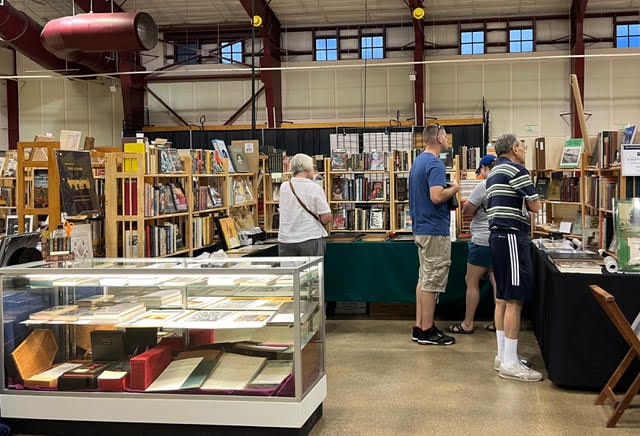 people look at books at the Rocky Mountain Book and Paper Fair in Castle Rock, CO