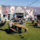 people and dogs gathers at the Skiptown Rino Dog Bar & Park in Denver, CO
