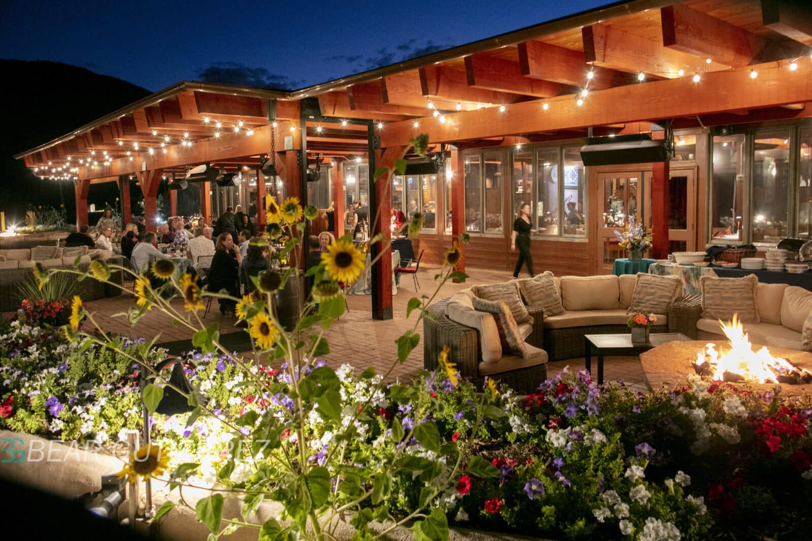 Evening outside showing covered patio dining at The Fort Restaurant in Colorado