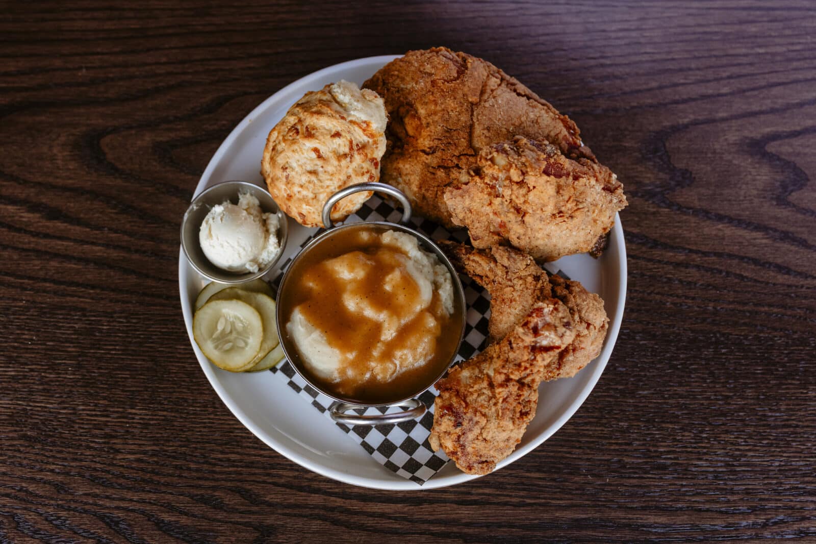 Close up of a plate of fried chicken, mashed potatoes, and biscuit at The Post restaurant in Colorado