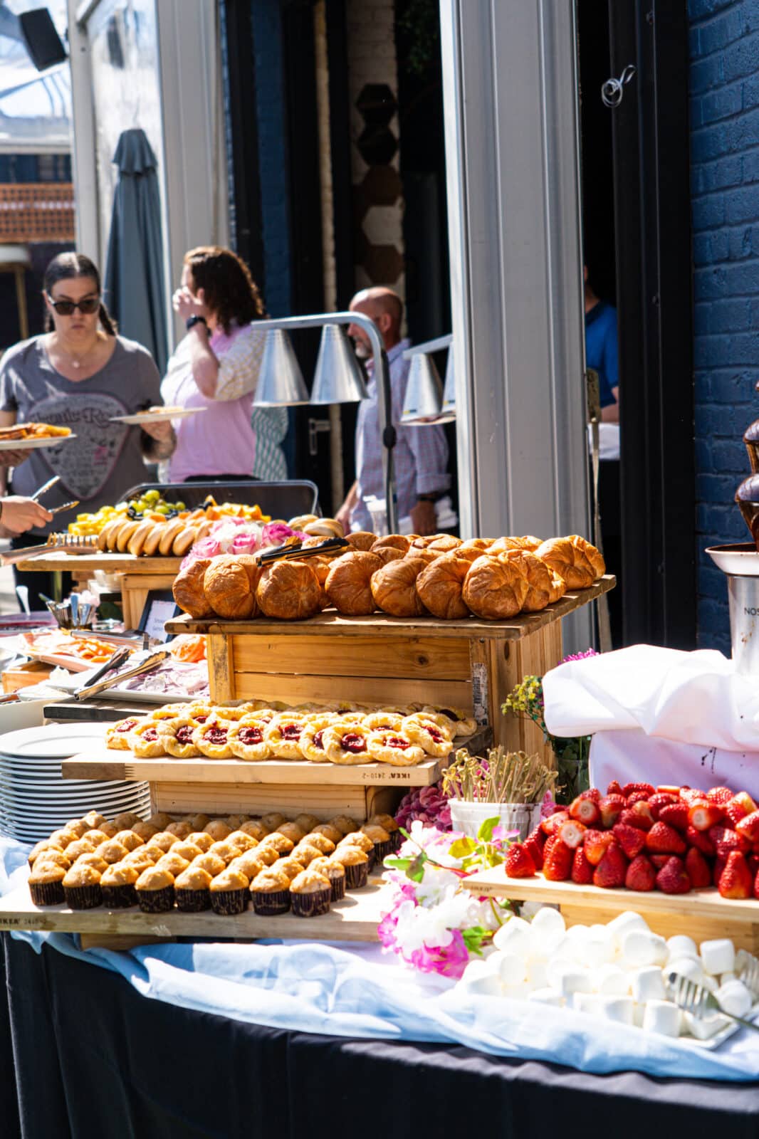 close up of brunch buffet showing pastries and strawberries at Wonderyard Garden in Denver