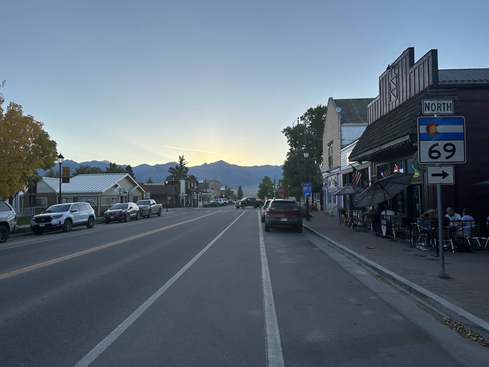 sun setting behind the mountains behind Main Street in Westcliffe, Colorado