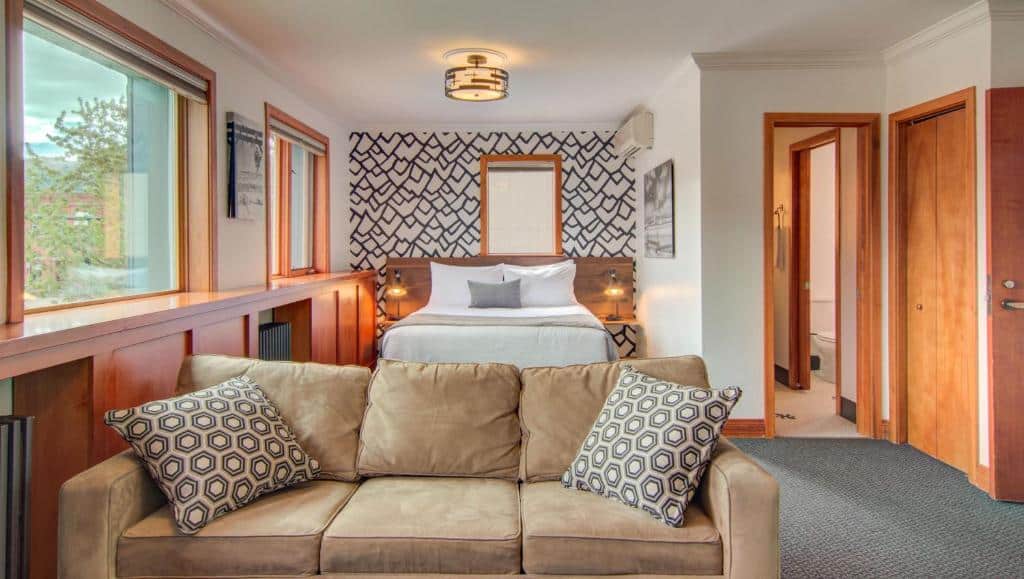 couch and bed in a hotel room at Hotel Bristol in Steamboat Springs