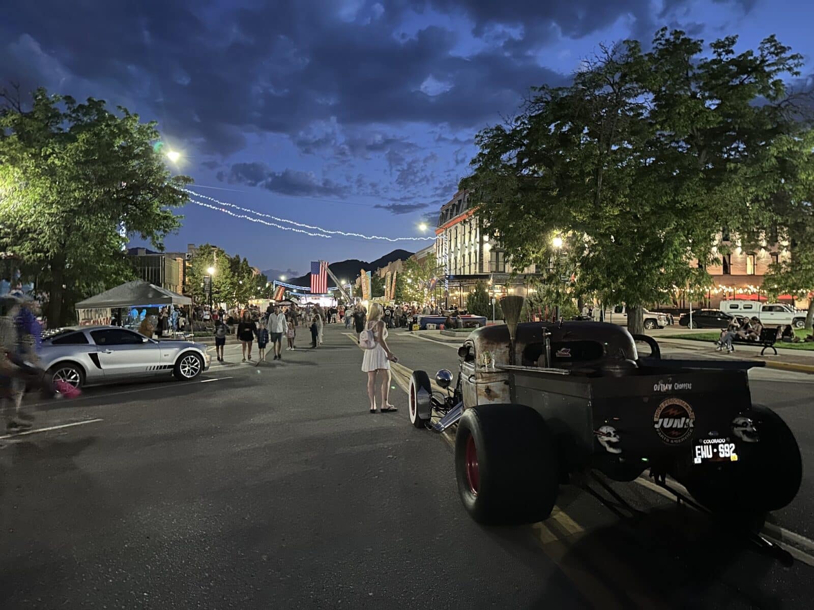 Car show in Canon City at night with Hotel St. Cloud in background