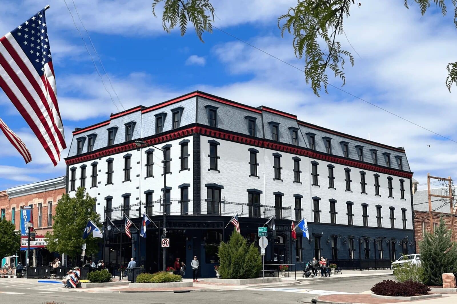 exterior of Hotel St. Cloud with a US Flag hanging across the street