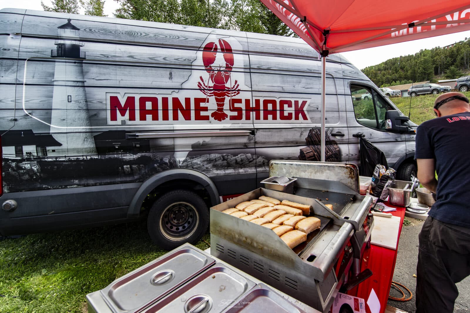 man cooks on a grill for Maine Shack at the Nederland Jazz & Wine Festival