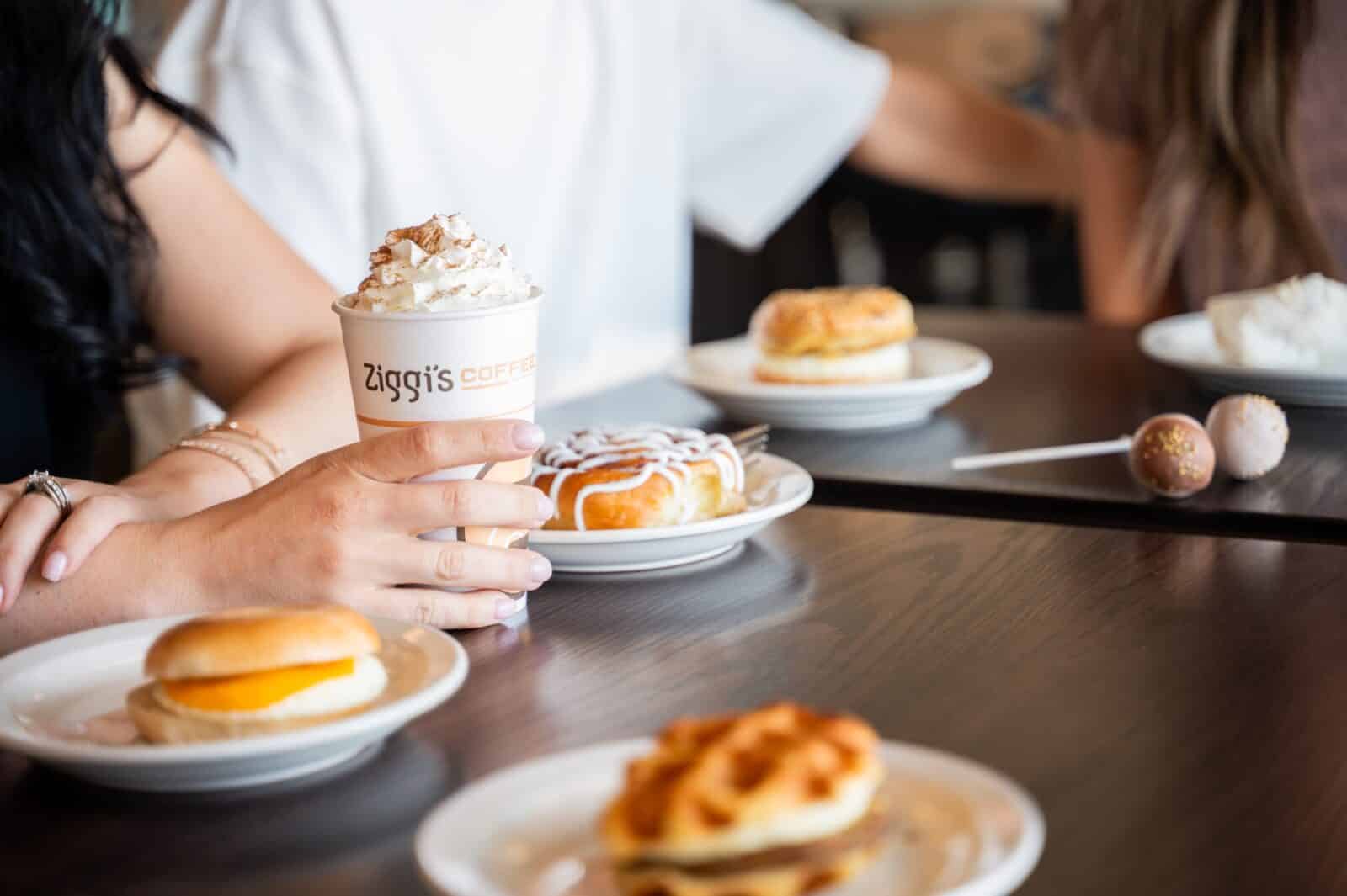 breakfast sandwiches and cinnamon bun on the table at Ziggi's