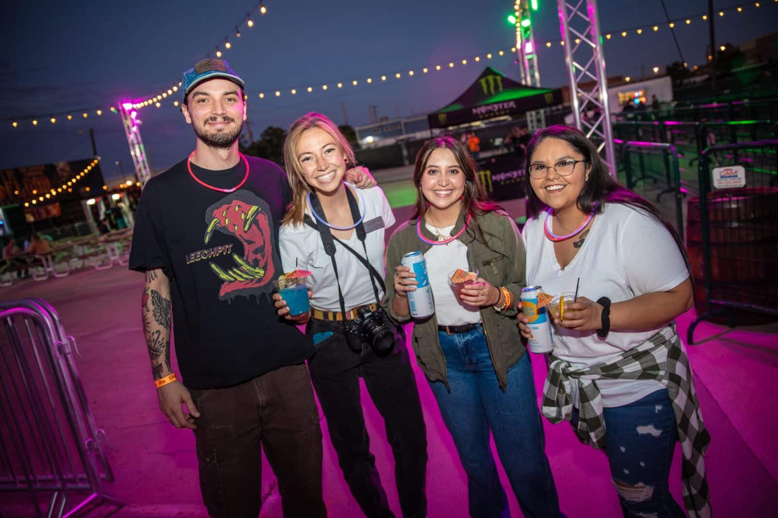 group poses for pictures with drinks at 13th Floor Haunted House in Denver