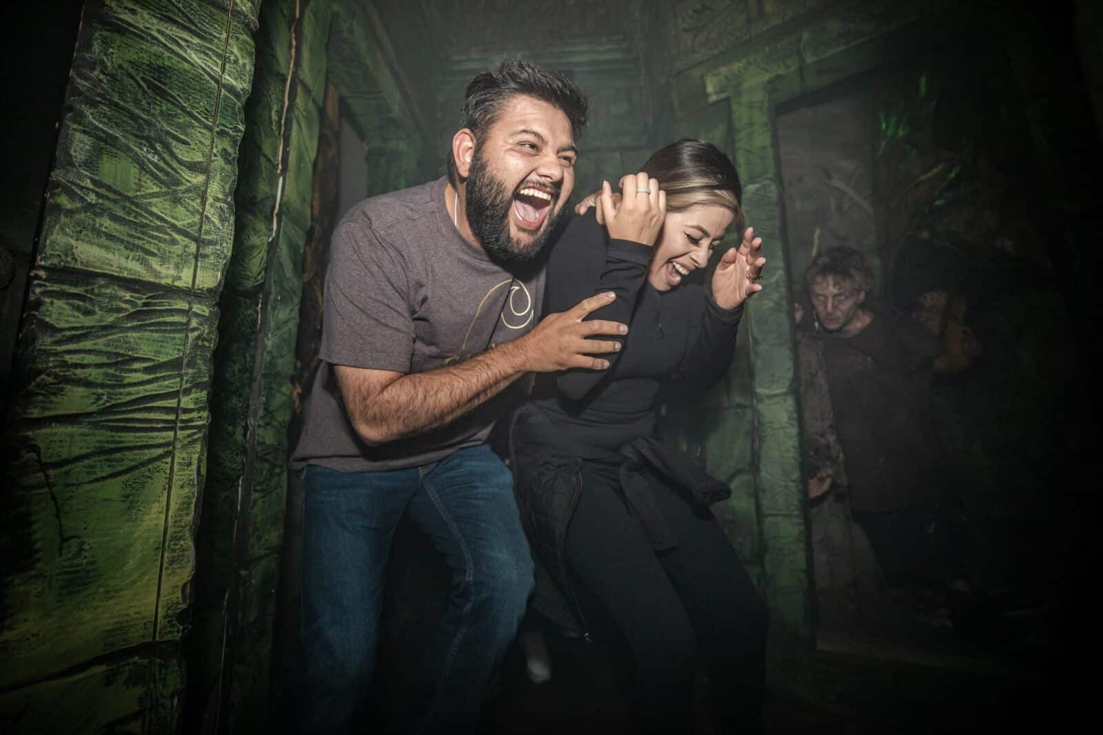 man and a woman scared touring the 13th Floor Haunted House in Denver