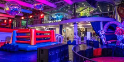 interior of Bounce Empire in Lafayette, Colorado showing stage, inflatables and upstairs bar