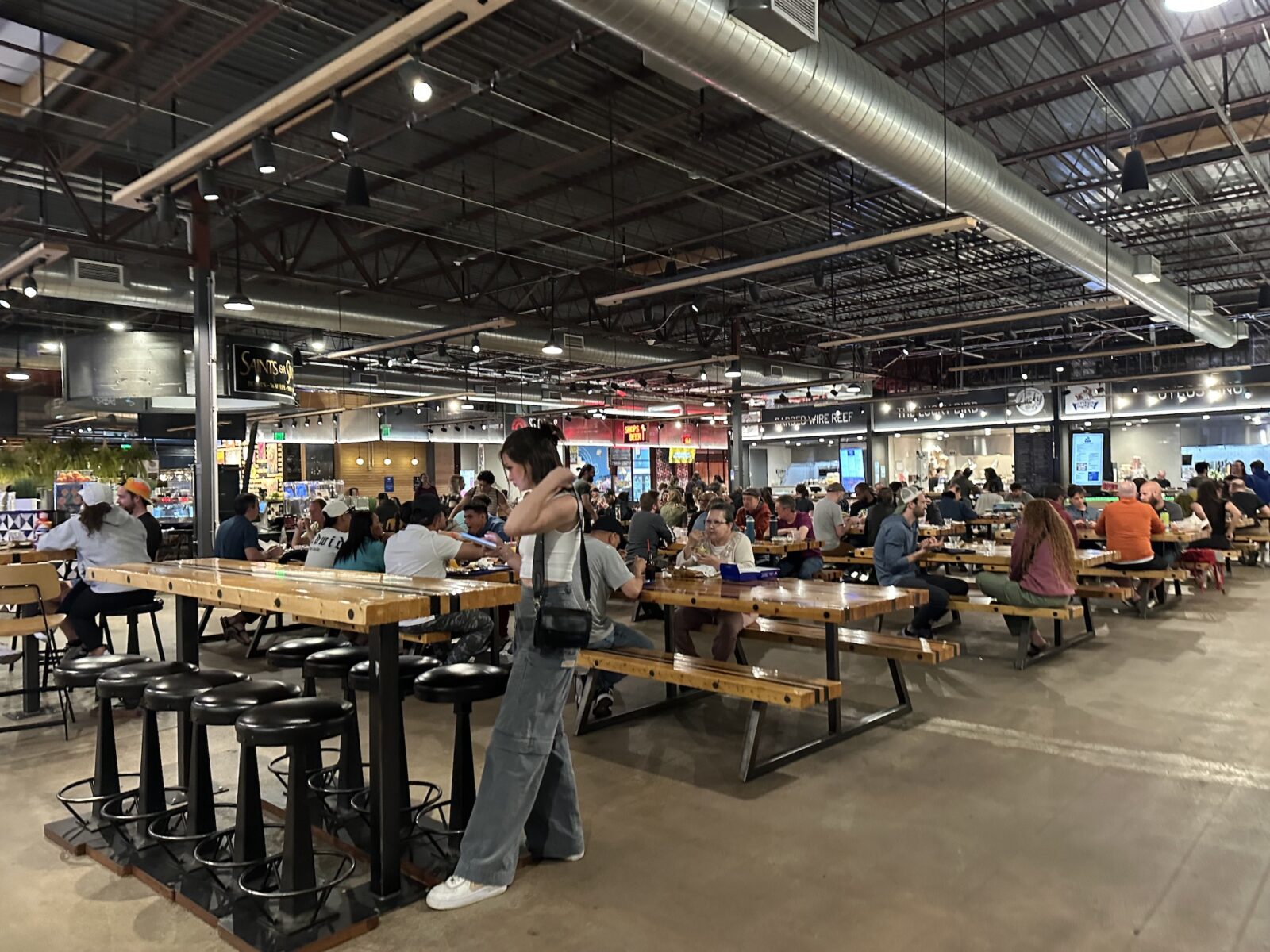 Picnic tables surrounded by fast-casual restaurants in Edgewater Public Market