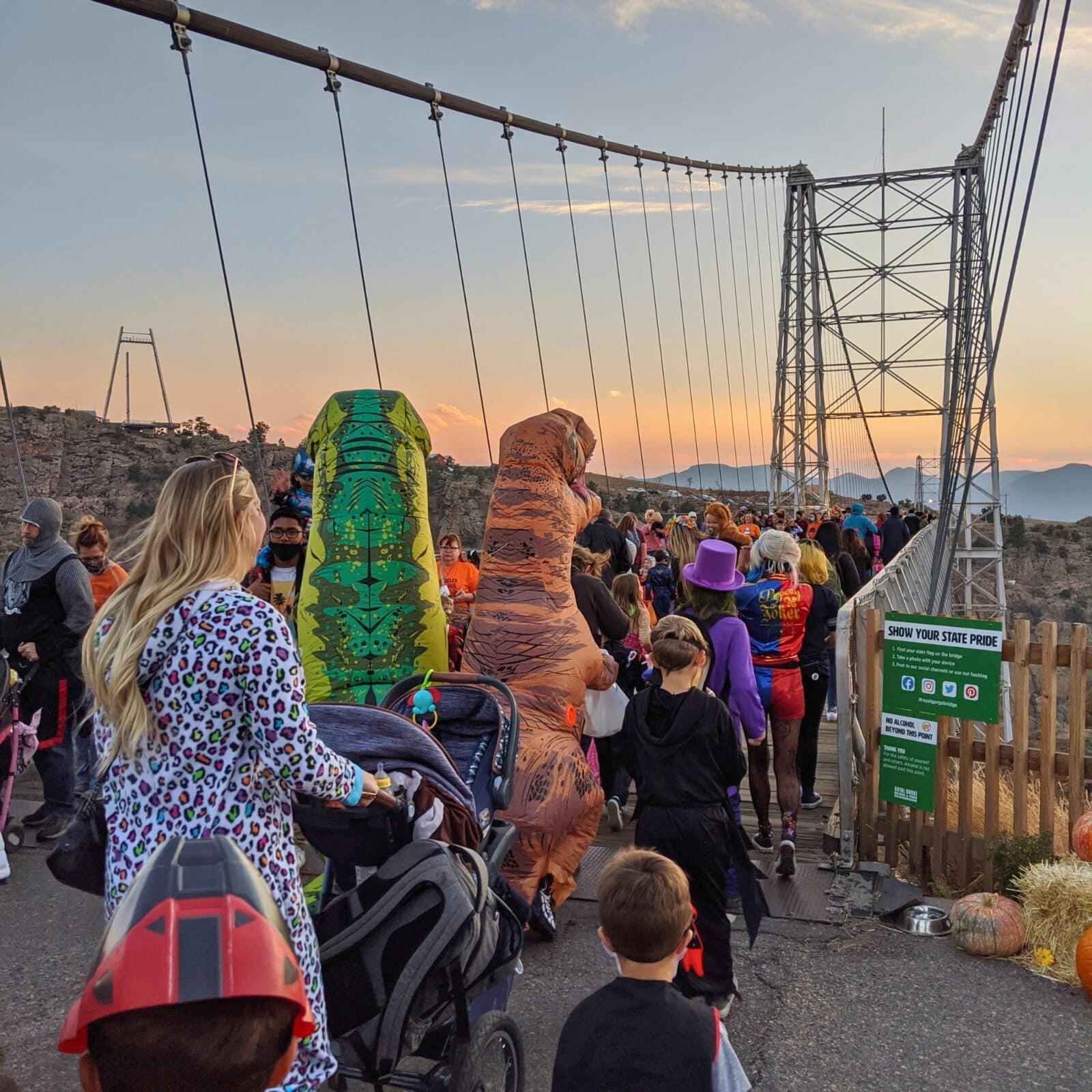 families in costumes waiting to the cross the Royal Bridge at sunset for Boo at the Bridge