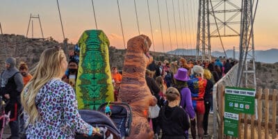 families in costumes waiting to the cross the Royal Bridge at sunset for Boo at the Bridge