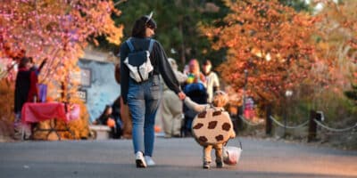 Mom and son hold hands while trick or treating at Boo at the Zoo in Colorado Springs