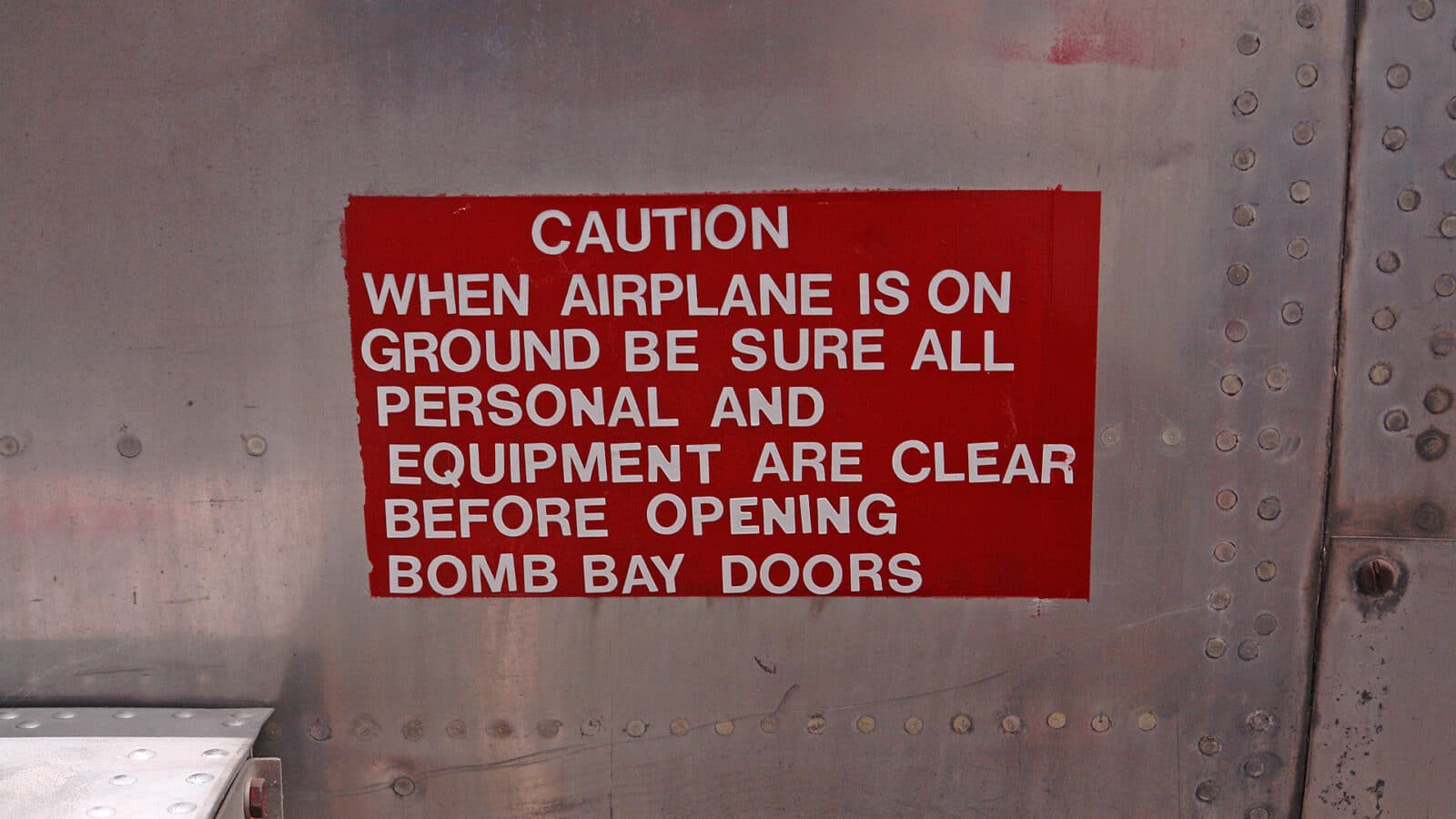 warning message written on wall at Pueblo Aircraft Museum in Southern Colorado