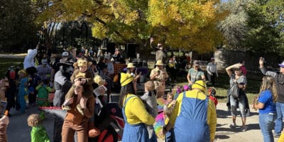 crowd of people in costumes at the Pueblo ZooBoo event with fall colors