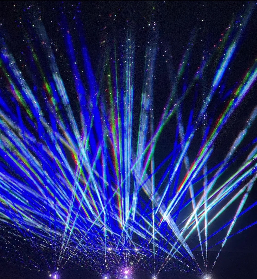 tall light display with blues and greens at the Aurora Borealis Festival in Colorado