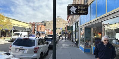 the Maverick Potter storefront sign in downtown Salida with "S" mountain in background