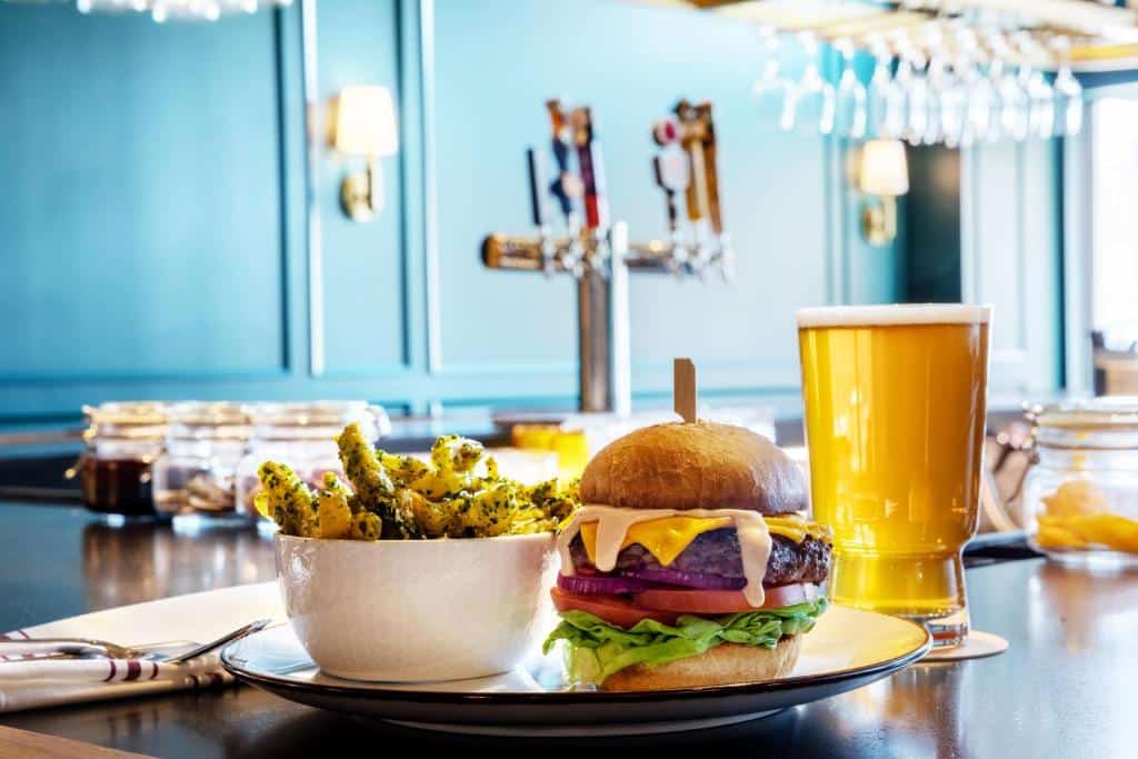 cheeseburger and beer on the bar The Benson Hotel in Aurora, Colorado