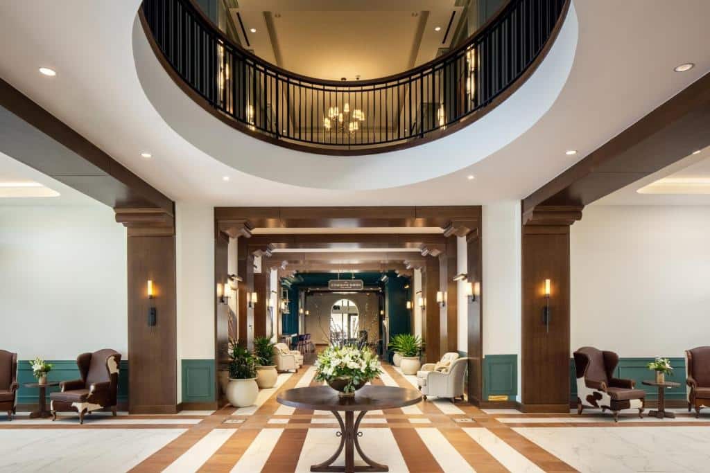 upscale hotel lobby showing high circular opening in ceiling up to second floor at The Benson Hotel in Aurora, Colorado