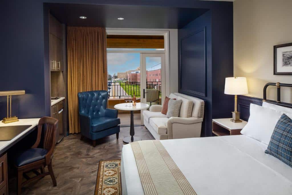 suite with couch and kitchenette at The Benson Hotel in Aurora, Colorado