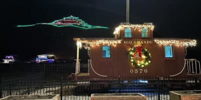 A huge lit up Christmas tree on the "S" hill in Salida and a Christmas decorated railroad car