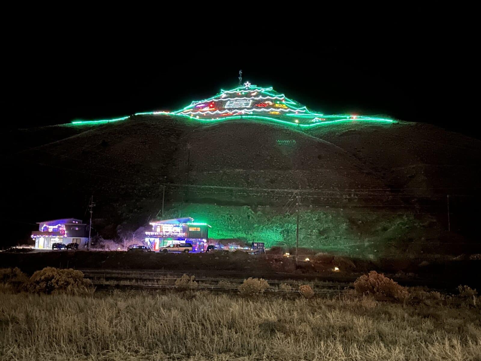 close-up looking up at the lit-up Christmas Tree Mountain in Salida Colorado
