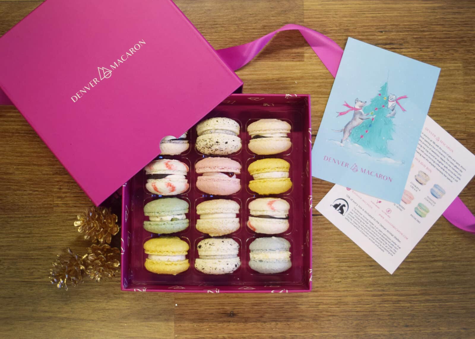 opened pink box of macarons with holiday card from Denver Macaron