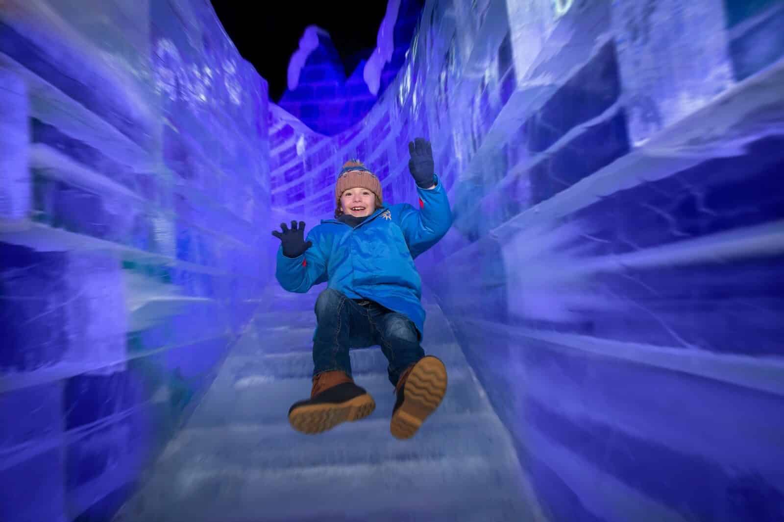 kid slides down an indoor ice slide at Gaylord Rockies in Aurora, Colorado