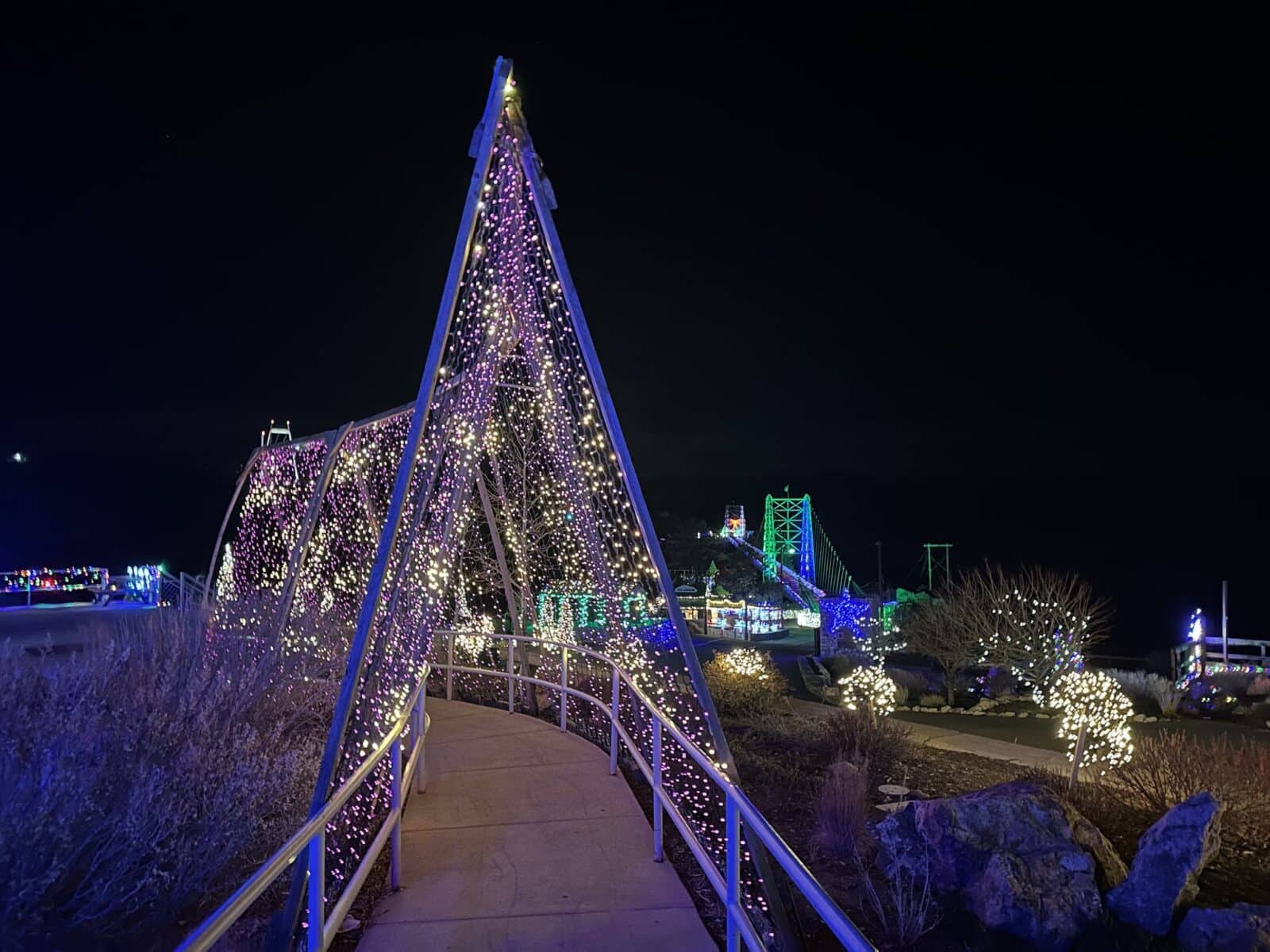 a tunnel of lights on a pathway leading to the Royal Gorge Bridge of Lights