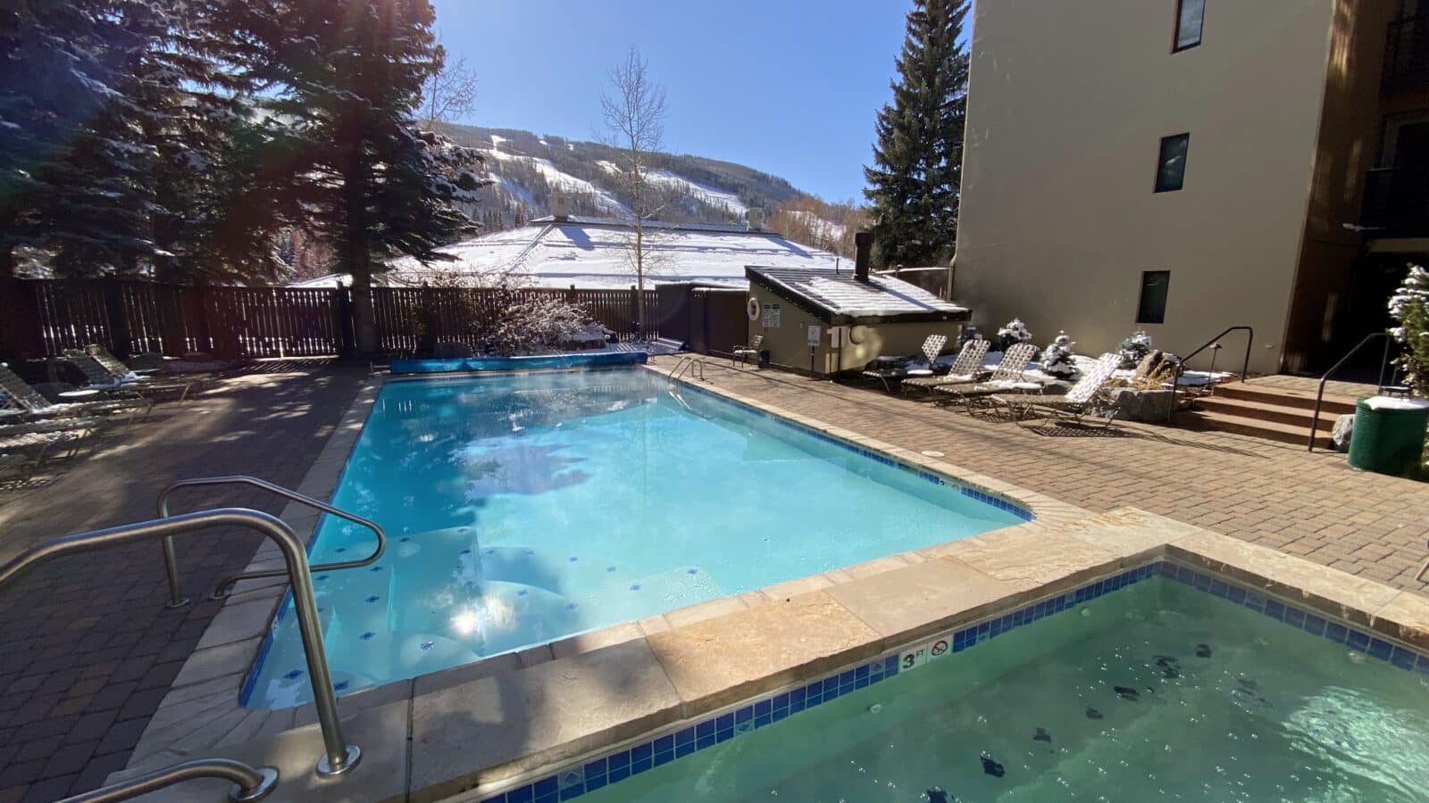 outdoor swimming pool and hot tub at Vail International Condominiums