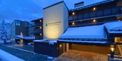 snow covered exterior of Vail International Condominiums at sunrise in winter