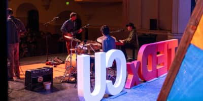 looking at stage sign for TEDxCU from behind
