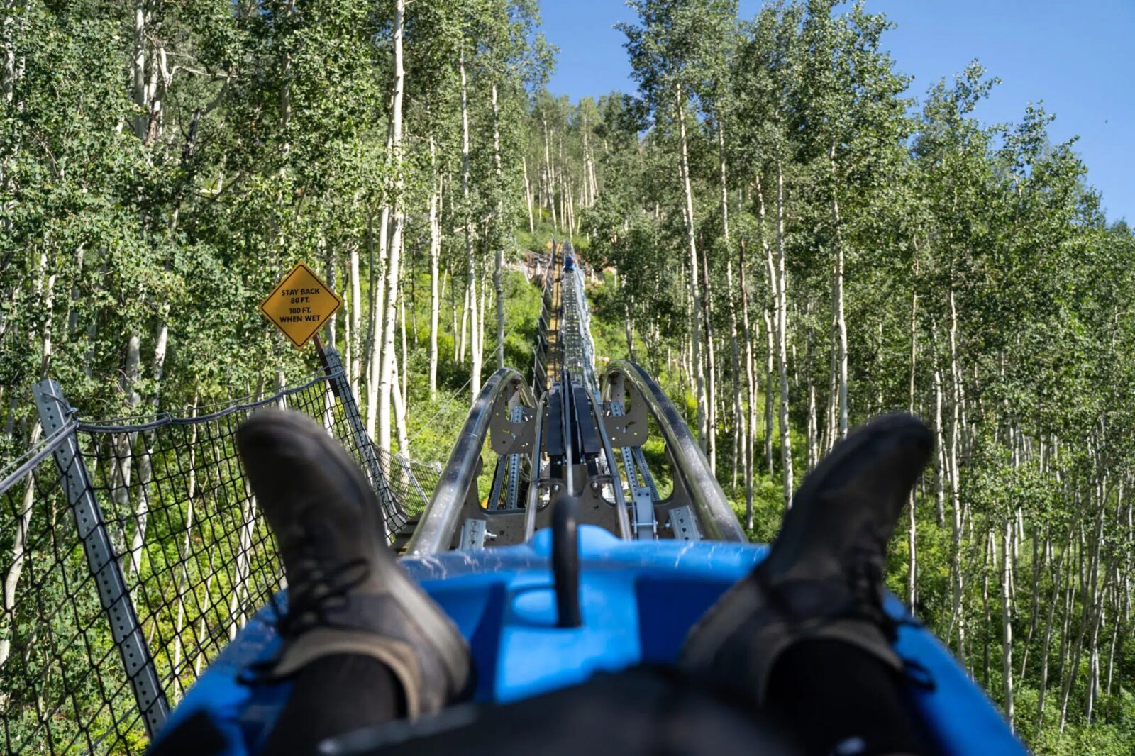 looking at a person's boots heading up the mountain coaster at Purgatory Resort