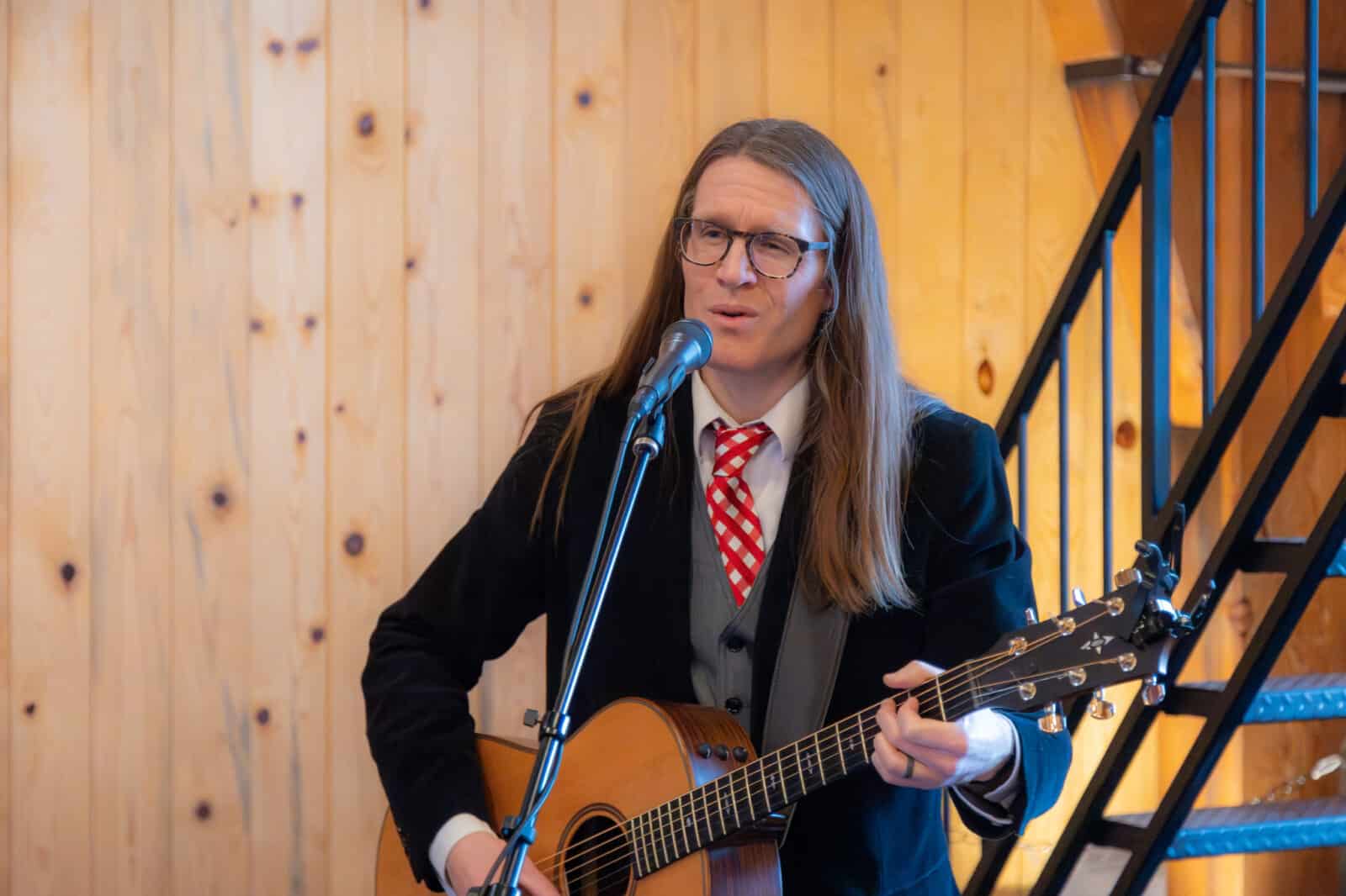 man playing guitar at the Loveland Valentine's Day Group Wedding