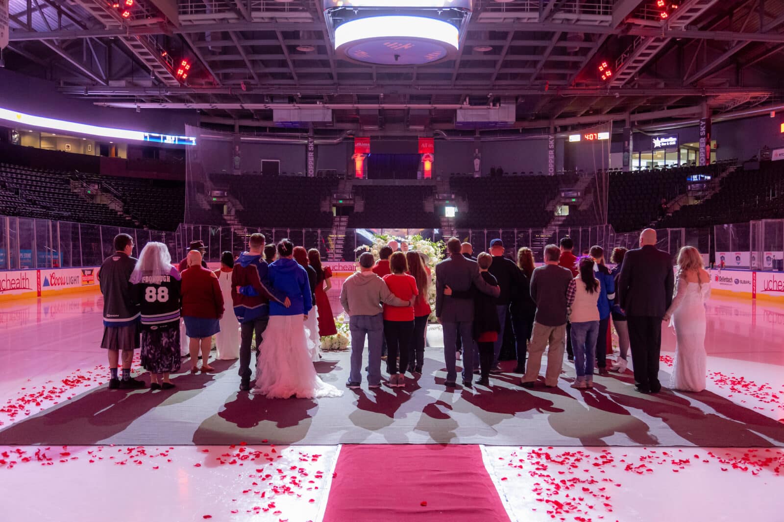 view from back of couples lined up on the ice rink at Loveland Valentine's Day Group Wedding
