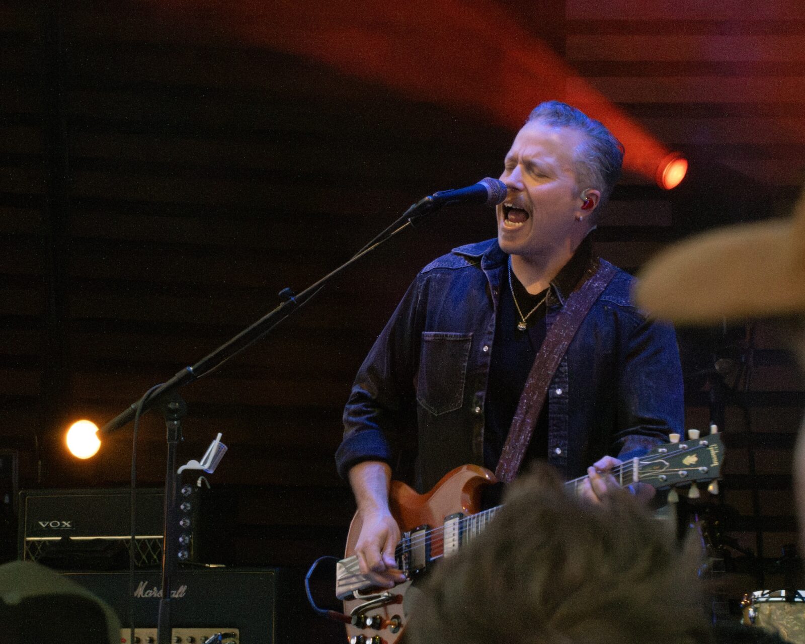 man plays guitar and sings on stage at the Dillon Amphitheater in Summit County, Colorado