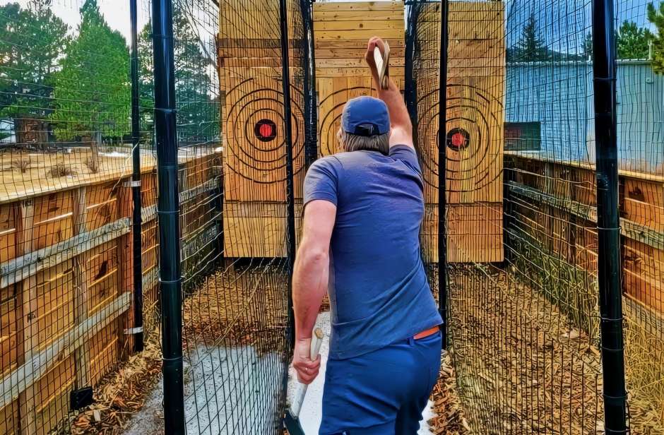man throwing an axe at a target in Estes Park